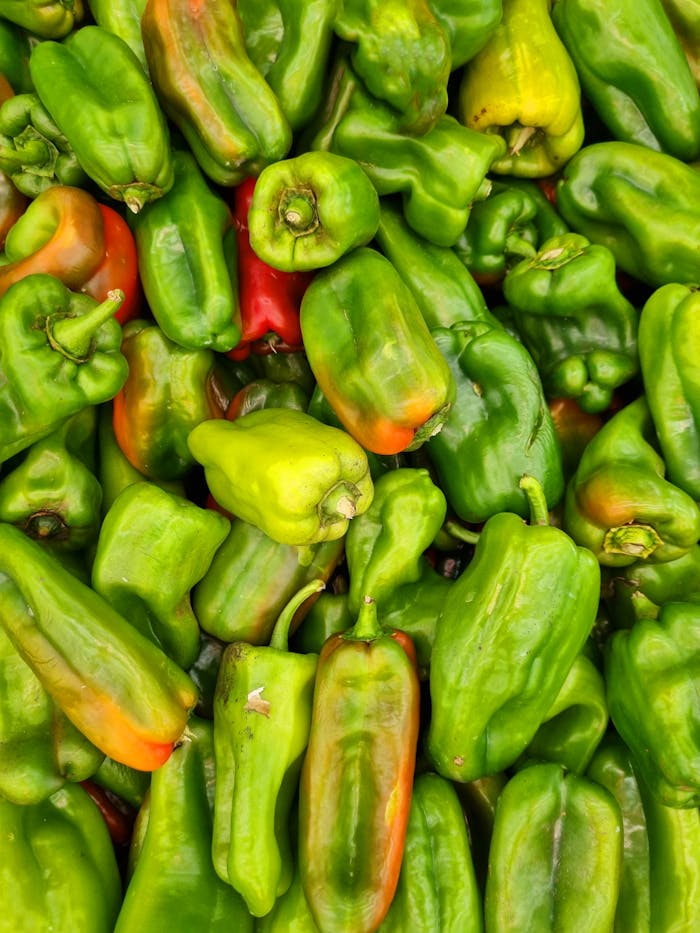 creative Close-up of vibrant green bell peppers at a market in Brasil.