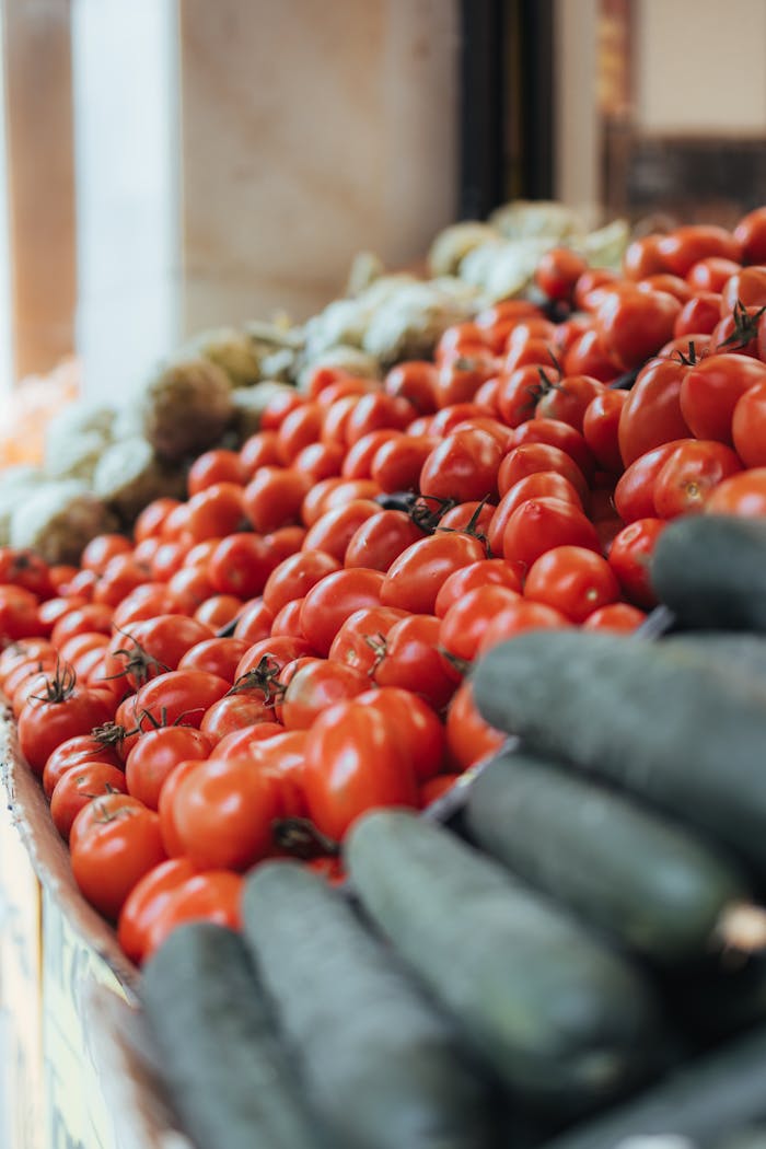 digital Vibrant tomatoes and cucumbers on display at a local market in Barcelona, Spain.